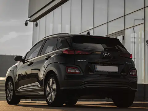 A dark compact SUV parked beside a glass building