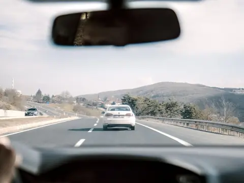 Traffic on a divided highway, seen through the windshield