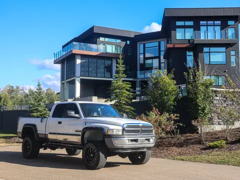 A pickup parked in a driveway in front of a modern house
